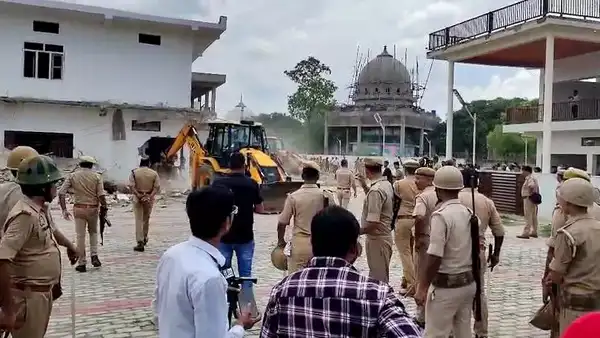 Balrampur, Jul 08 (ANI): Uttar Pradesh administration, in the presence of police, demolishes the property belonging to Chhangur Baba, who is the alleged mastermind of a religious conversion gang, at Utraula in Balrampur on Tuesday. He was arrested by Uttar Pradesh ATS. (ANI Video Grab) Balrampur, Jul 08 (ANI): Uttar Pradesh administration, in the presence of police...