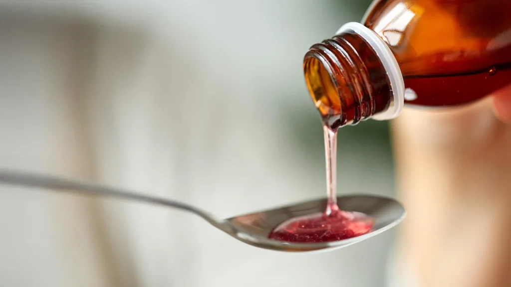pouring-cough-medicine-onto-spoon.webp.webp