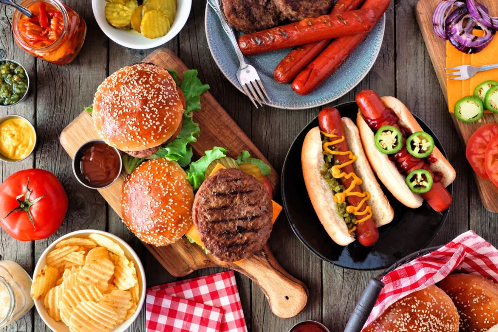 summerbbqfoodtablescenewithhotdogandhamburger.jpg